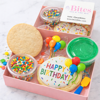 Birthday cookie set with sprinkles, balloons, and 'Happy Birthday' decoration in a pink box.