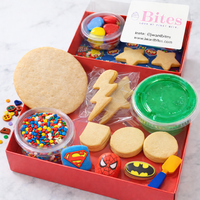 Cookie decorating kit with cookies, icing, sprinkles, and tools in a red box.