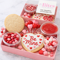 Valentine's Day themed cookie box with heart-shaped cookies and candies.
